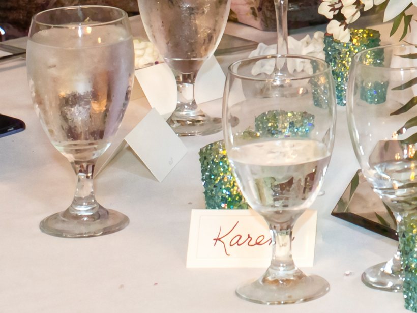 The same table after CraterView.ai denoising, at the photograph's own pixels: the grain gone from the cloth and the glass, and the handwriting and the glitter kept