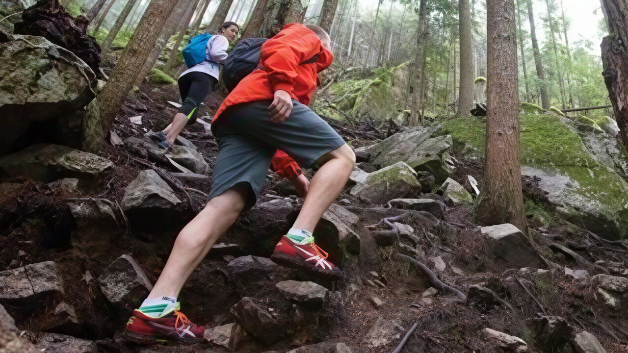The same hikers after a 4× CraterView.ai enhancement and small face enhancement: the laces, the fabric of the jacket and the grit on the rocks resolved, and the nearer hiker's face drawn clearly