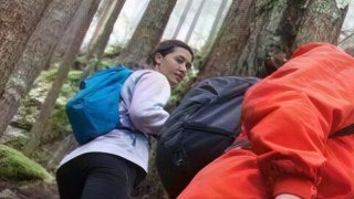 The same crop after CraterView.ai small face enhancement: the hiker's face redrawn with clear eyes, nose and mouth