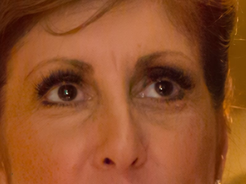 The same part enlarged by a third with Enhance and binning at 3x3, the grain gone from her skin and eyes, her lashes, irises and the strands of her hair sharp